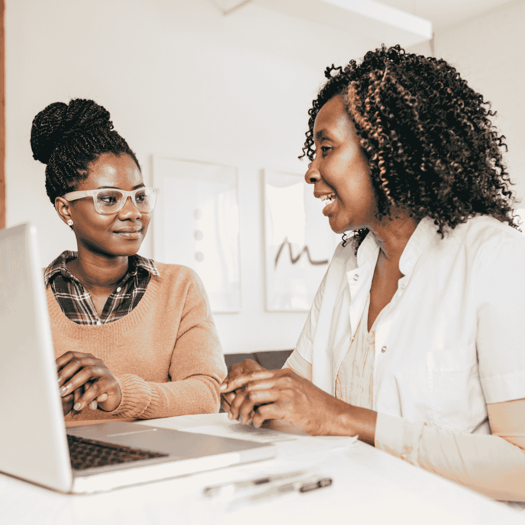 Women Talking in front of a laptop